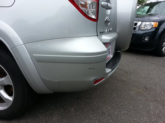 Scraped on rear bumper left by auto specialists