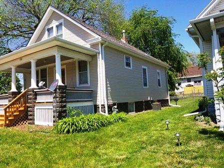 Older home with a gable roof and covered porch.