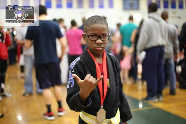 Kameron throwing up the Shaka after a good day on the mats.