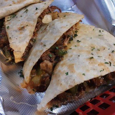 "Smoked Brisket Quesadilla"  Tender and Juicy Smoked Brisket with Grilled Onions, Peppers, Cheddar Jack Cheese, and BBQ Sauce.