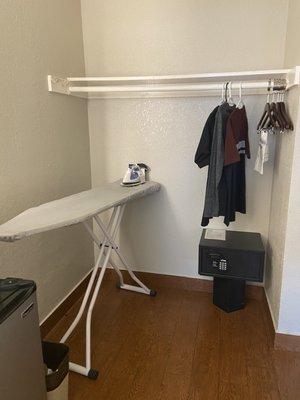 Ironing Board Along With An Iron . A Small Open Closet And A Safe Provided