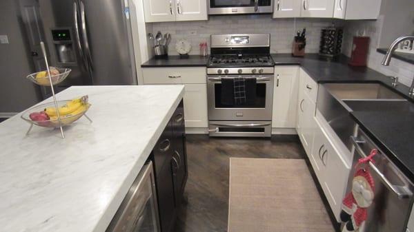 satin finish cambrian black granite. Perimeter with a 2" mitered Carrara  island