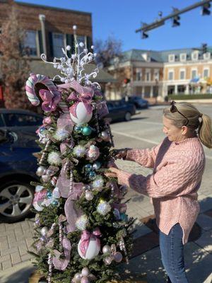 Decorating a tree to showcase our community spirit during the holidays on Academy St.