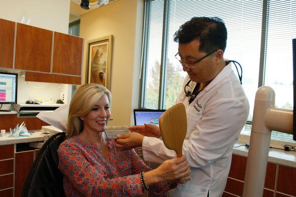 Dr. Kim working with patient on her new smile.