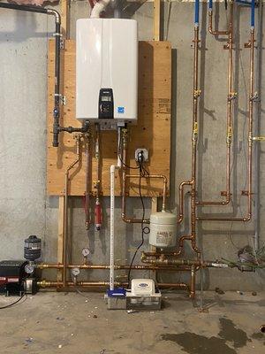 Navien NPE A tankless water heater and a booster pump for domestic water