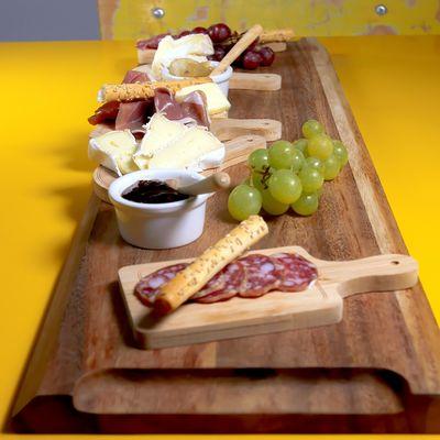 The "Choice of 2 cheeses and 2 charcuteries + 1 side" platter on our Scandinavian yellow table!