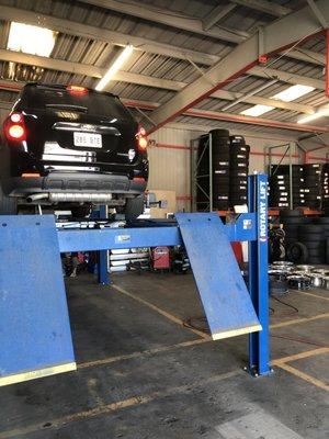 Computerized Alignment Machine, inventory of New and Used Tires in Shop Area.