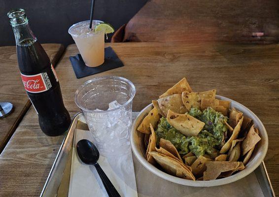 Coke and guacamole and chips