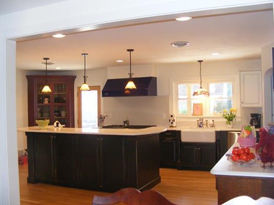 Kitchen after combining rooms and hall to make larger room. New hardwood floor. New lighting.