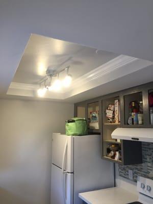 Old halogen light fixture removed and replaced with crown molding and new LED light fixture.