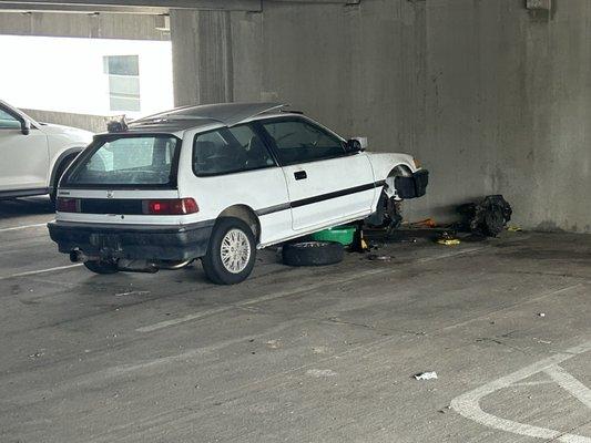 Broken down junkie car in the parking garage. I complained twice and nothing's been done about it for two months.