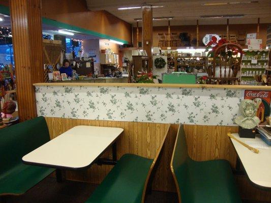 Ice cream parlor seating and view towards the front desk & checkout area.