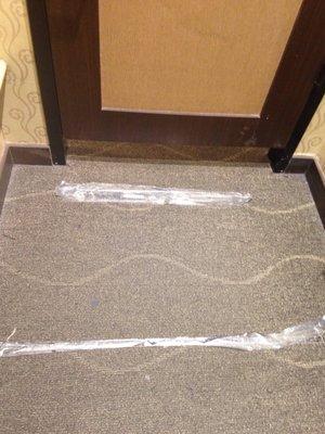 Carpet in dressing room taped together.