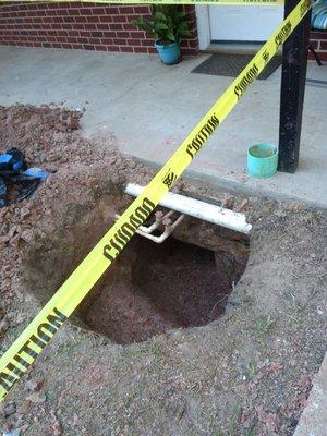 Hole dug for repair in front of my door