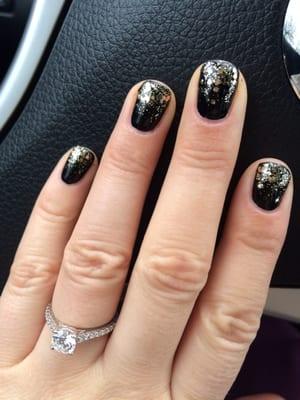 Black OPI polish with a gold glitter design