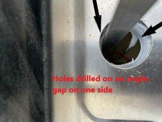 Holes cut on an angle, misaligned, and too small for kitchen hardware