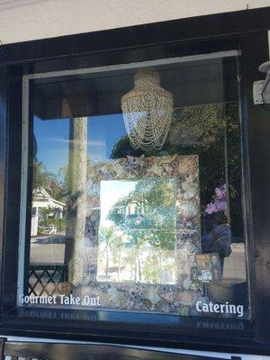 Newlin's is chock-full of fantastic gourmet food, along with art, unique tablescaping pieces and gifts! Here a seashell mirror in the window