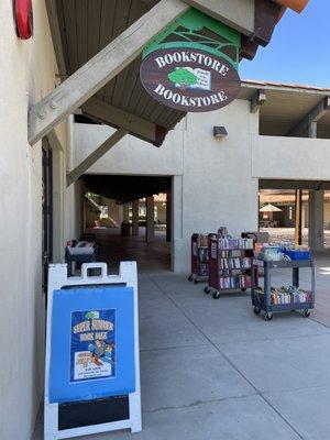 Outside the bookstore with the sales carts out front