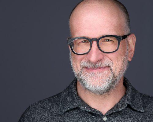 Headshot of man with glasses