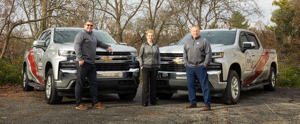 A team photo with a few of our new fleet trucks