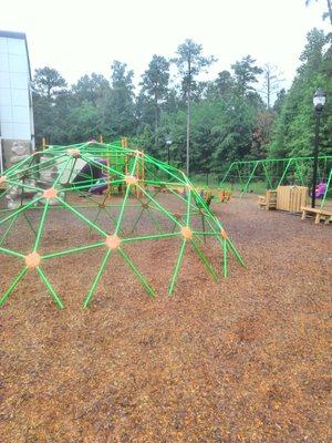 The kiddy playground had swings , slided. Jungle gyms