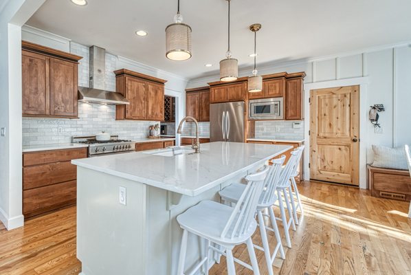 New quartz countertops with small subway tile backsplash.