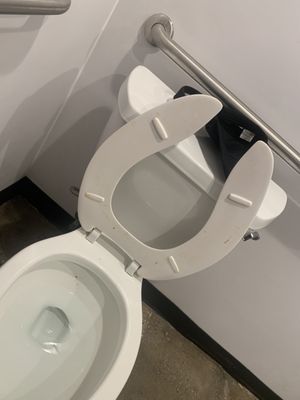 dirt commode with employees hat left on toilet...