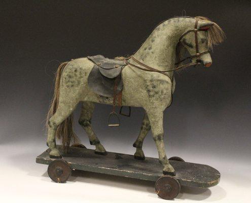 Early toys, this one is a ride-on / pull toy - specializing in early toys, tin wind-ups and more.