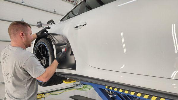 Installing matte black rock guards on a Porsche GT3