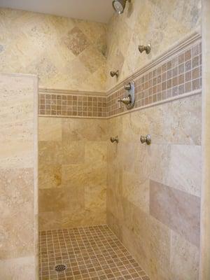 Golden travertine shower in San Clemente.