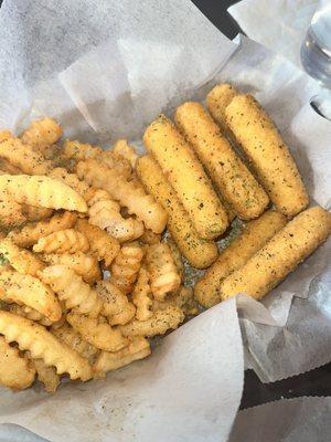 Cajun mozzarella sticks with French fries.