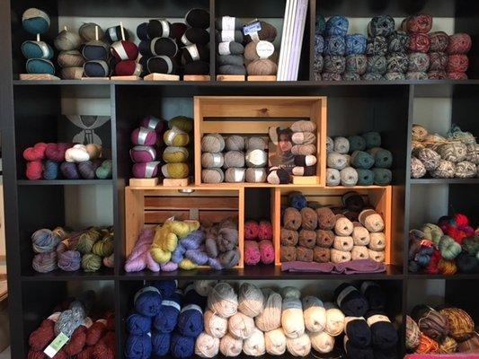 One of our fully stocked yarn walls featuring, Debbie Bliss, Feederbrook Farm, The Fibre Company, HiKoo, Lopi, Mountain Colors, and Zealana