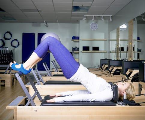 Erika bridging on a Studio Reformer