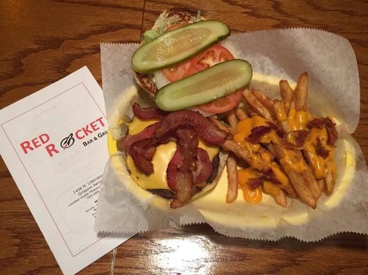 All American Burger- 
 8oz steak burger topped with bacon, lettuce, tomato and onion. 
 Served with Fries