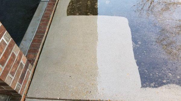 Power washing concrete with surface washer.