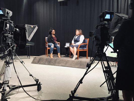 Our Founder & CEO (L) interviewing the owner of a local beauty/skin company in a local TV production studio.