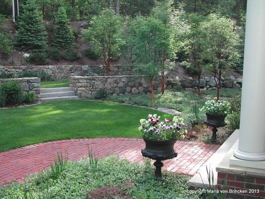 Front walk garden with containers, plantings, terrace stone walls, steps, sitting area, grove.