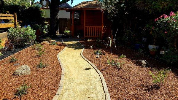 Gold fines (decomposed granite) walkway with natural stone borders. California native drought tolerant landscape.