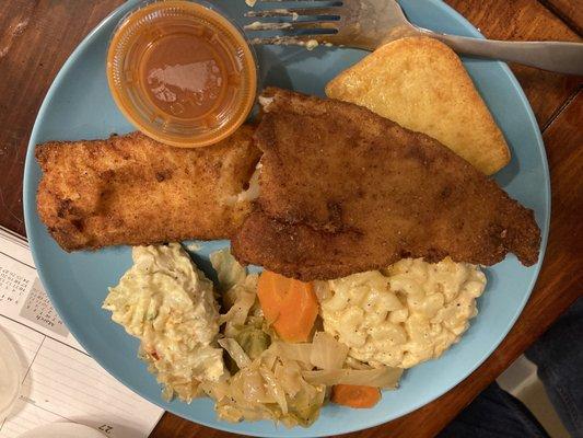 Cod fillet dinner with Mac and cheese, homemade cornbread, and cabbage.