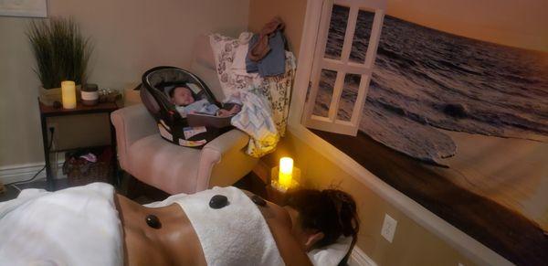 Baby sleeping peacefully while mommy gets a lovely swedish massage.