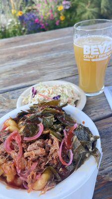 Pulled pork bowl served with collard greens, pickled red onions, Mac 'n cheese, side of cole slaw and a Hazy IPA from Bevel Craft Brewing.