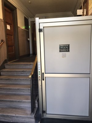 This elevator but only takes you up this little tiny staircase but if you're in a wheelchair someone has to carry you up to the second level