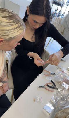 Angel teaching her permanent jewelry class