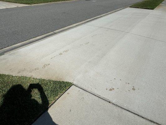 Footprints left by Employee on newly power washed driveway