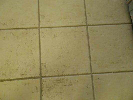 Dirty tile and grout when we arrived.