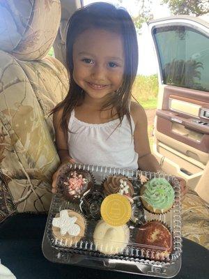 my baby girl nāwai, taste testing holiday cupcakes.