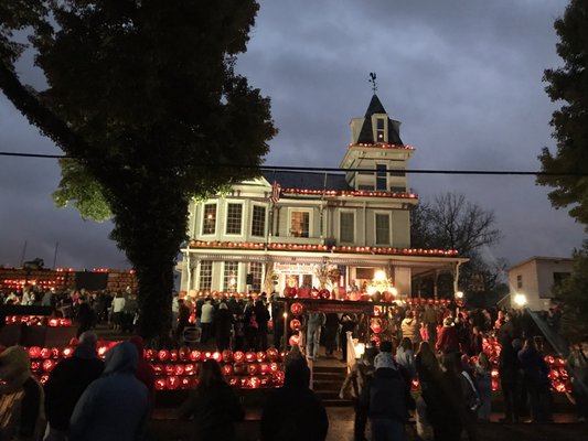 Pumpkins are lit up at dusk.