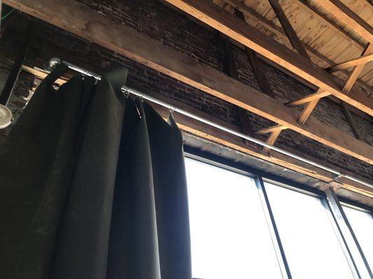 Put up a pipe to hang a heavy Canvas curtain at a business