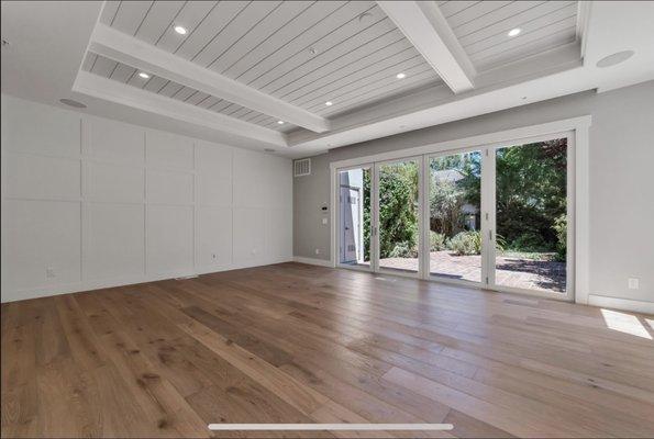 Boards and batten wall, newly installed folding system door, with tongue and groove ceiling.