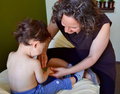 Children often laugh and play while receiving acupressure.